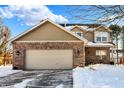 Two-story brick home with attached garage and snowy front yard at 10565 Camille Ct, Indianapolis, IN 46236