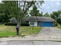 Ranch house with a blue garage door and mailbox at 10915 Cherry Lake Pl, Indianapolis, IN 46235