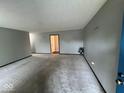 Spacious living room with grey walls and carpeting at 10915 Cherry Lake Pl, Indianapolis, IN 46235