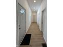 Bright hallway with light grey door and wood-look floors at 1256 Kappes St, Indianapolis, IN 46221