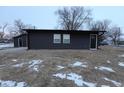 Single story home with dark siding and a black front door at 1384 Cross St, Martinsville, IN 46151