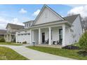 Beautiful white home featuring a charming front porch perfect for relaxing with a view at 19349 Sumrall Pl, Westfield, IN 46074