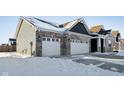 Two-story home with a three-car garage and snow-covered landscaping at 2364 Eagle Ave, Plainfield, IN 46168