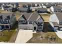 Aerial view of a two-story home featuring a three car garage in a suburban neighborhood at 4061 Omaha Dr, Bargersville, IN 46106