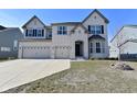 Charming two-story home with a three car garage and well-manicured front lawn at 4061 Omaha Dr, Bargersville, IN 46106