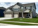 Charming two-story home featuring a manicured lawn, brick accents, and a welcoming front porch at 5442 W Turnbuckle Pl, McCordsville, IN 46055