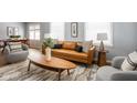 Cozy living room featuring a leather sofa and mid century modern coffee table at 6005 Ralston Ave, Indianapolis, IN 46220