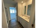 Double vanity bathroom with a large mirror and a walk-in shower at 6618 Sulgrove Pl, Indianapolis, IN 46221