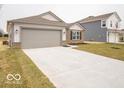 Attractive single-story home with a two-car garage, concrete driveway, and a well-kept lawn at 6618 Sulgrove Pl, Indianapolis, IN 46221