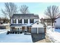 Inviting two-story home with blue shutters, well-maintained landscaping, and a convenient two-car garage at 7669 Camberwood Dr, Indianapolis, IN 46268