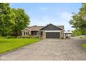 Lovely single-Gathering home featuring an attached garage, paved driveway, and well-maintained lawn and garden at 7775 N Kitchen Rd, Mooresville, IN 46158