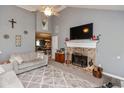 Cozy living room featuring a brick fireplace, a plush rug, and comfortable seating arrangements at 7775 N Kitchen Rd, Mooresville, IN 46158