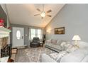 Inviting living room featuring vaulted ceilings, neutral paint, modern furnishings, and plush carpeting at 7775 N Kitchen Rd, Mooresville, IN 46158