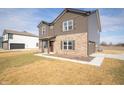 Attractive two-story home showcasing brown siding, brick accents, and attached garage on a sunny day at 7872 Magnolia St, New Palestine, IN 46163