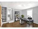 Home office with built-in shelving and modern desk at 837 Birch Ave, Indianapolis, IN 46221