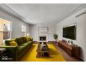Spacious living room with hardwood floors, fireplace, and large windows at 9210 Briarclift Rd, Indianapolis, IN 46256