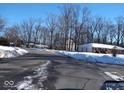Residential street scene with snow-covered yards and homes at 941 Sleepy Hollow Pl, Greenwood, IN 46142
