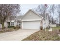 Tan brick ranch home with attached garage at 10832 Harness Way, Indianapolis, IN 46239