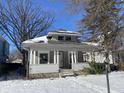 Gray house with front porch, freshly painted, needs landscaping at 1318 N Lasalle St, Indianapolis, IN 46201