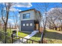 A modern two-story home with clean lines, a welcoming front entrance, and a well-maintained lawn and black metal fence at 1656 Roosevelt Ave, Indianapolis, IN 46218