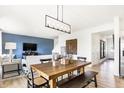 Open-concept living space with a dining area, blue accent wall, and modern decor at 18632 Walsh Way, Westfield, IN 46074