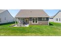 Spacious backyard featuring a covered patio and a well-maintained lawn at 19357 Sumrall Pl, Westfield, IN 46074
