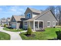 Side view of a charming two-story home with lush green grass and landscaping at 19357 Sumrall Pl, Westfield, IN 46074