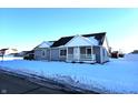 Gray house with white trim, covered porch, and snowy front yard at 2103 Twelve Oaks Dr, Shelbyville, IN 46176