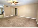 Living room with neutral walls, carpeting, and ceiling fan at 2103 Twelve Oaks Dr, Shelbyville, IN 46176