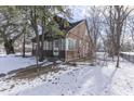 Brown house with green trim, snow on the ground at 3135 E Southport Rd, Indianapolis, IN 46227