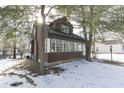 House exterior showcasing a side view and snowy yard at 3135 E Southport Rd, Indianapolis, IN 46227