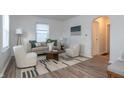 Bright living room with beige sofa, and two armchairs at 3501 Caroline Ave, Indianapolis, IN 46218