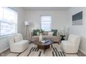 Living room with light beige sofa and two armchairs at 3501 Caroline Ave, Indianapolis, IN 46218