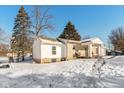 Side view of a ranch house with snowy yard and visible basement at 4202 W Mooresville Rd, Indianapolis, IN 46221