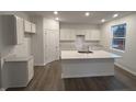 Bright kitchen with white cabinetry, a large center island, and modern finishes at 5133 Cartland Dr, Indianapolis, IN 46239