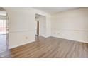 Empty dining room with light walls, wood-look floors, and access to kitchen at 5334 Thrasher Dr, Indianapolis, IN 46254