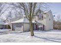 Two-story house with gray siding, red shutters, and a snowy front yard at 5334 Thrasher Dr, Indianapolis, IN 46254