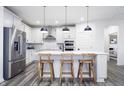 Modern kitchen featuring white cabinets, stainless steel appliances, and an island with seating at 5780 Stetson Dr, Whitestown, IN 46052