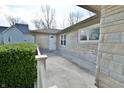 Welcoming entrance with stone exterior, covered porch and well-maintained landscaping at 67 W Brookville Rd, Fountaintown, IN 46130