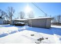Ranch home exterior with attached garage; winter scene with snow covering the ground at 67 W Brookville Rd, Fountaintown, IN 46130
