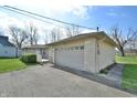 Spacious two-car garage with an attached driveway and well-maintained surroundings at 67 W Brookville Rd, Fountaintown, IN 46130