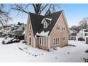 Tan two-story house with snow covered yard at 714 Berkley Rd, Indianapolis, IN 46208