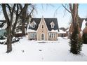 Tan two-story house with snow covered yard at 714 Berkley Rd, Indianapolis, IN 46208