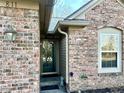 Close up of a brick home's entrance, showcasing a welcoming doorway and charming exterior details at 811 Buffalo Run Way, Indianapolis, IN 46227