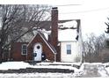 Brick and siding house with snow covered roof and yard at 906 Raible Ave, Anderson, IN 46011