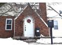 White front door with wreath on brick house exterior at 906 Raible Ave, Anderson, IN 46011