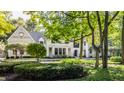 Elegant white brick home nestled in a lush green landscape at 11091 Crooked Stick Ln, Carmel, IN 46032