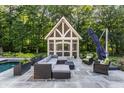 Relaxing patio area with sectional seating and a modern pool at 11091 Crooked Stick Ln, Carmel, IN 46032