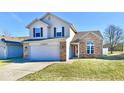 Two-story house with attached garage and well-maintained lawn at 12983 Wingstem Ct, Fishers, IN 46038
