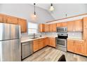 Modern kitchen features stainless steel appliances and oak cabinets at 12983 Wingstem Ct, Fishers, IN 46038